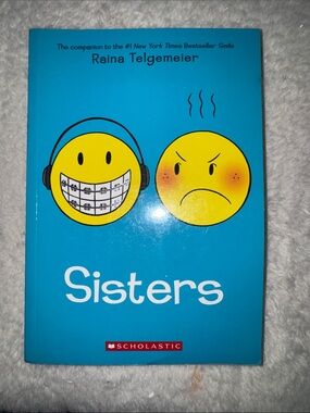 Scholastic Blue Cover Graphic Novel with Yellow Emoji Faces
